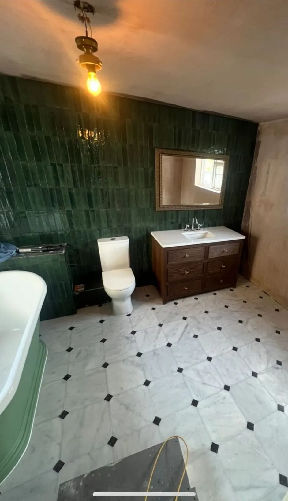 Traditional bathroom renovation in Reading with green tiled wall, green bath and wooden vanity