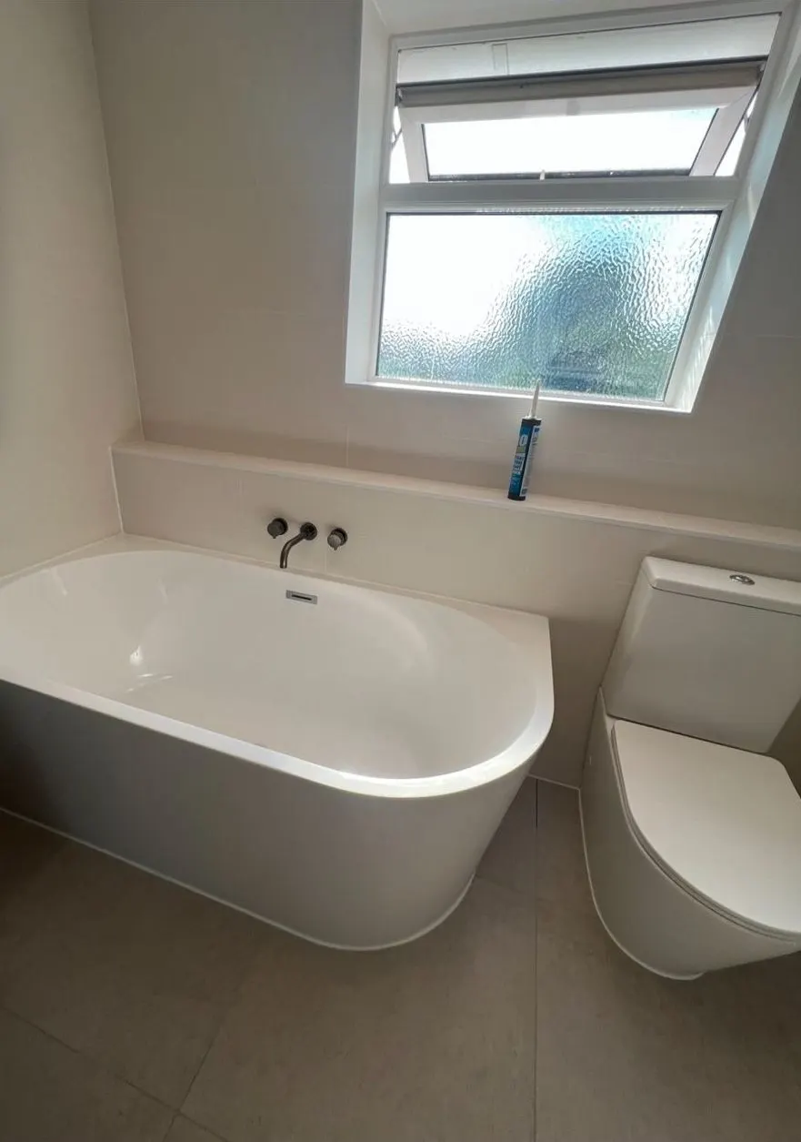 Back-to-wall bath with wall-mounted tap and close-coupled toilet, new bathroom Reading