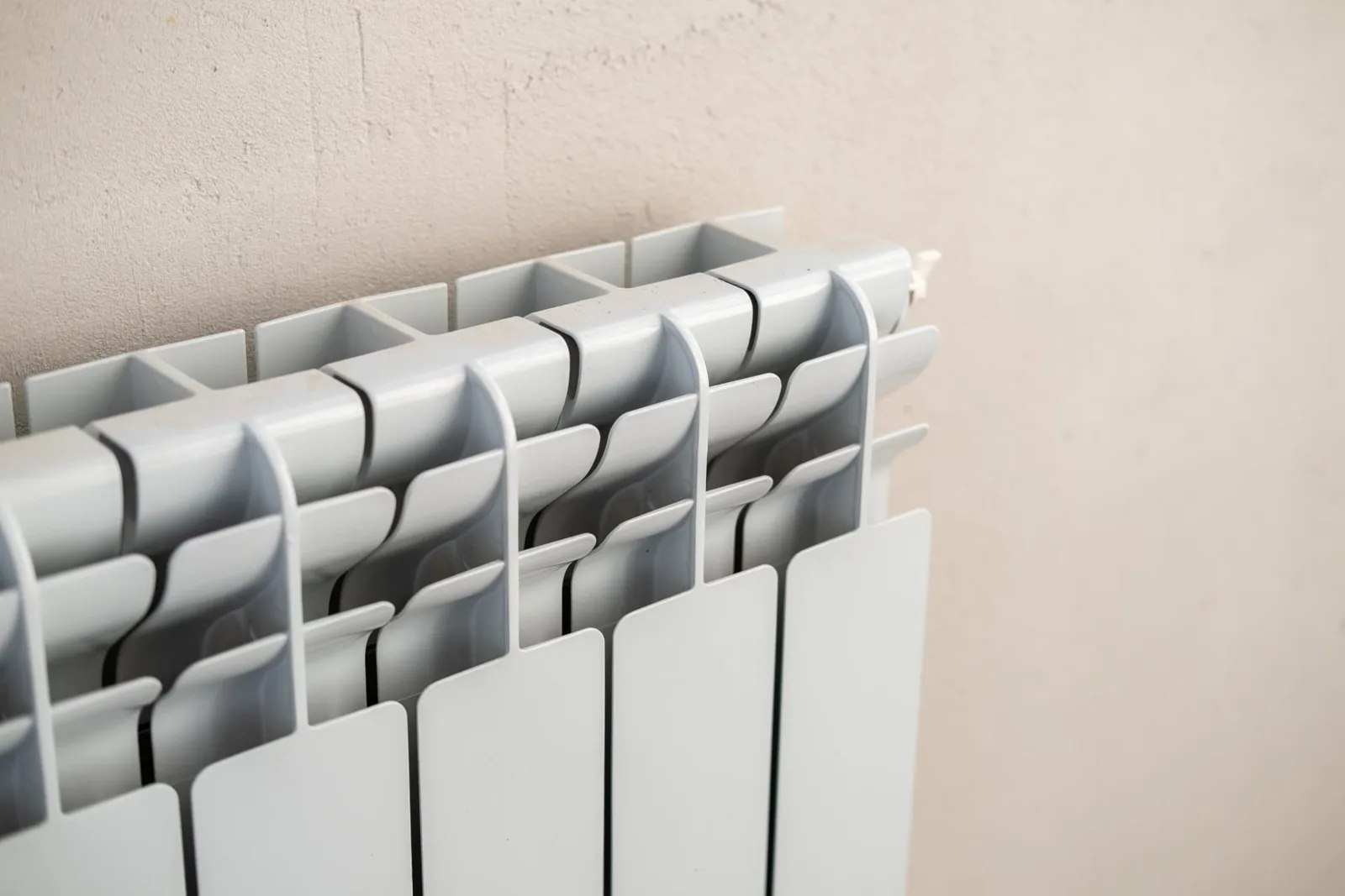 Close-up of a white aluminium column radiator, heating repairs in Reading