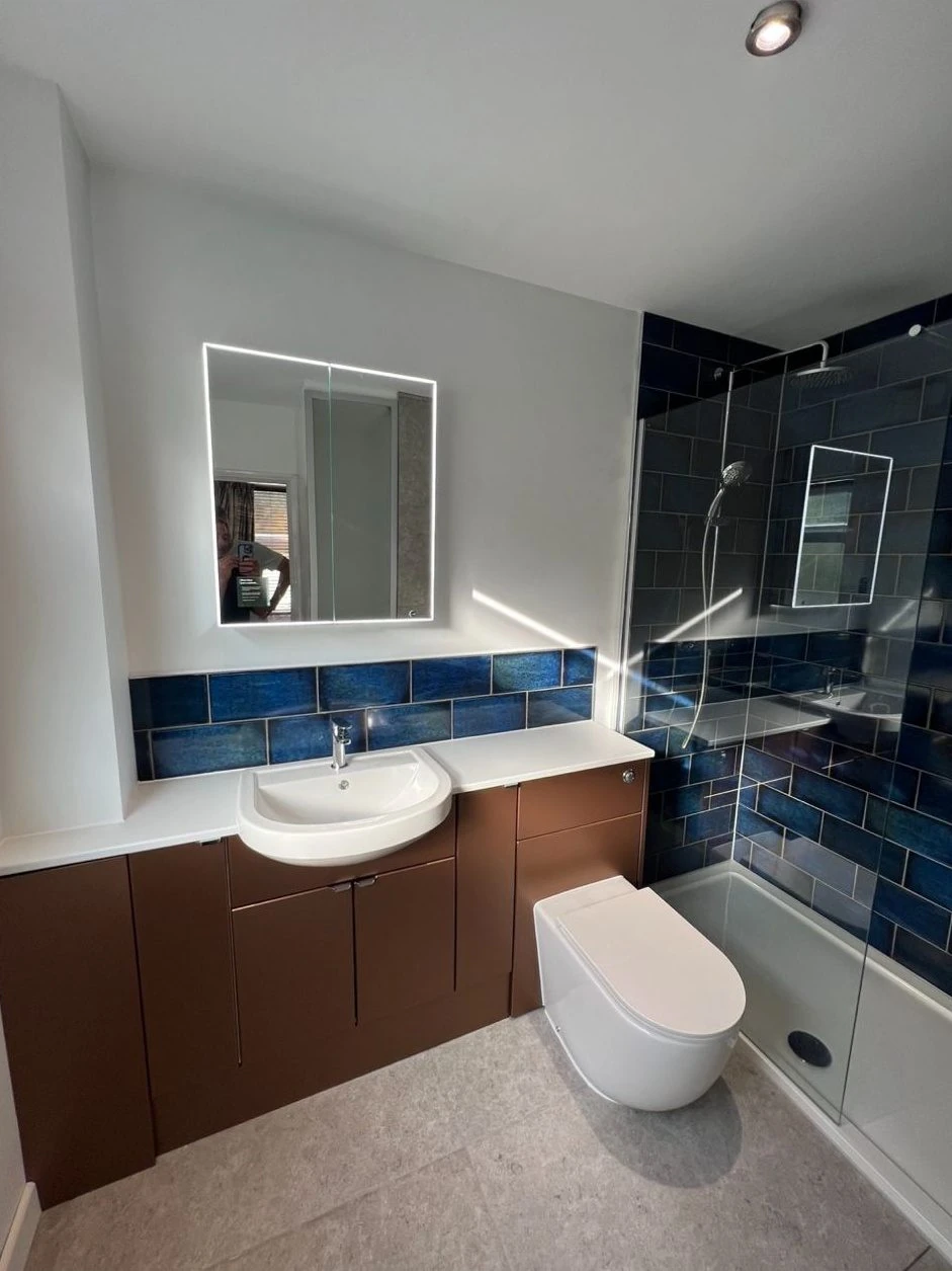Bathroom refit with fitted furniture, walk-in shower and blue gloss wall tiles