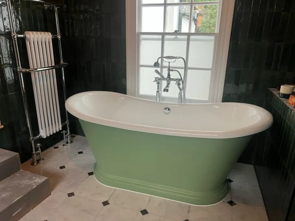 Bathroom renovation with green roll-top bath, deck-mounted bath shower mixer and column towel radiator